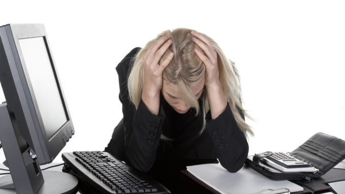 Tired woman slumping over desk